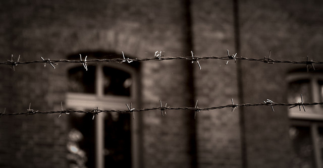 Behind the barbed wire